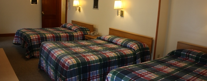 Three beds with plaid bedding